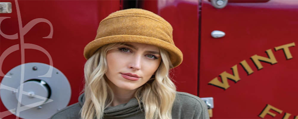 woman wears a wool beanie and sitting on a firetruck